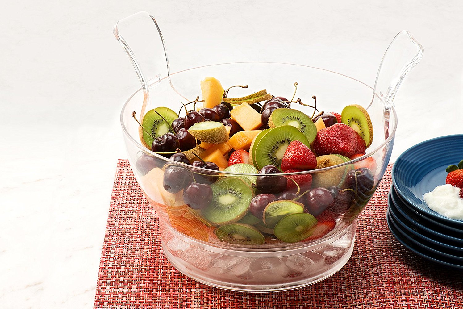 Chilled salad bowl on ice with spoon and fork
